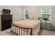 Comfortable bedroom featuring carpeting, modern furniture, and windows for natural light at 320 Everly Mist Way, Wake Forest, NC 27587