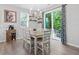 Bright dining area featuring modern lighting, neutral tones and sliding glass doors to outdoor patio at 320 Everly Mist Way, Wake Forest, NC 27587