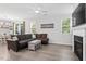 Inviting living room featuring a comfortable sofa, modern furniture, and an electric fireplace at 320 Everly Mist Way, Wake Forest, NC 27587
