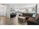 Comfortable living room featuring modern furniture, a sleek console, and view of the kitchen at 320 Everly Mist Way, Wake Forest, NC 27587
