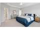 Well-lit main bedroom boasting neutral colors, carpeting, and a private ensuite bathroom at 320 Everly Mist Way, Wake Forest, NC 27587