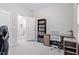 Study area with a sleek desk, comfortable seating, and stylish bookcase at 320 Everly Mist Way, Wake Forest, NC 27587