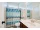 Bathroom featuring a vanity with a sink and a toilet with a blue patterned shower curtain at 3911 Morvan Way, Raleigh, NC 27612
