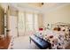 Bright bedroom featuring carpeted floors, a seating bench at the foot of the bed and sun-drenched windows at 3911 Morvan Way, Raleigh, NC 27612