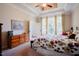 Bedroom featuring carpeted floors, a seating bench at the foot of the bed and sun-drenched windows at 3911 Morvan Way, Raleigh, NC 27612