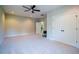 Empty bonus room with a ceiling fan, carpet flooring, and access to the hallway and closet at 3911 Morvan Way, Raleigh, NC 27612