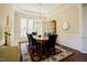 Dining room features a wood table, decorative rug, natural light and a china cabinet for storage and decor at 3911 Morvan Way, Raleigh, NC 27612