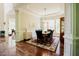 Dining room with hardwood floors, large window, decorative rug, and elegant chandelier at 3911 Morvan Way, Raleigh, NC 27612