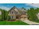 Charming two-story brick home with lush landscaping and a welcoming double garage at 3911 Morvan Way, Raleigh, NC 27612