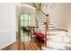 Grand foyer with a curved staircase, hardwood floors, and bright natural light at 3911 Morvan Way, Raleigh, NC 27612
