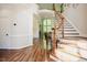 Elegant foyer featuring hardwood floors, staircase with ornate banister, and architectural details at 3911 Morvan Way, Raleigh, NC 27612