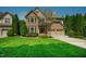 Two-story brick and siding home with a manicured lawn and a concrete driveway to a two car garage at 3911 Morvan Way, Raleigh, NC 27612