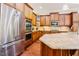 Kitchen features stainless steel appliances, granite countertop island and wood cabinets at 3911 Morvan Way, Raleigh, NC 27612