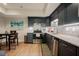 Lower-level kitchenette boasts stainless appliances, granite counters, and mosaic tile backsplash at 3911 Morvan Way, Raleigh, NC 27612