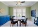 Living room featuring green walls, carpet flooring, bright natural lighting, and a ceiling fan at 3911 Morvan Way, Raleigh, NC 27612