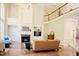 Cozy living room featuring a fireplace, built-in shelving, and a view of the upstairs balcony at 3911 Morvan Way, Raleigh, NC 27612