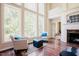 Bright living room with large windows, hardwood floors, and a cozy fireplace at 3911 Morvan Way, Raleigh, NC 27612