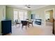 Living room with green walls, a ceiling fan, carpet flooring, a round table and four chairs at 3911 Morvan Way, Raleigh, NC 27612