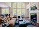 Spacious living room featuring tall windows, a fireplace, and hardwood floors at 3911 Morvan Way, Raleigh, NC 27612