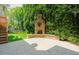 The brick patio features an inviting outdoor fireplace and a view of the fenced yard at 3911 Morvan Way, Raleigh, NC 27612