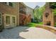 Spacious brick patio with an outdoor fireplace and stairs to a screened deck, ideal for outdoor entertaining at 3911 Morvan Way, Raleigh, NC 27612