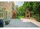 Spacious brick patio with an outdoor fireplace, stairs to upper screened deck, and access to the home's interior at 3911 Morvan Way, Raleigh, NC 27612
