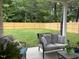 Relaxing back porch with comfortable seating and a serene view of the fenced backyard at 4001 Newby Rd, Rocky Mount, NC 27804
