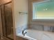 Well-lit bathroom with a shower and a soaking tub by the window at 4001 Newby Rd, Rocky Mount, NC 27804