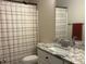 Bright bathroom with a granite vanity top and a shower with striped shower curtain at 4001 Newby Rd, Rocky Mount, NC 27804