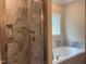 Relaxing bathroom with a separate shower and soaking tub by a window at 4001 Newby Rd, Rocky Mount, NC 27804