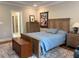 Comfortable bedroom with wooden furniture, lamp, and a cozy blue bedspread at 4001 Newby Rd, Rocky Mount, NC 27804