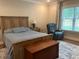 Relaxing bedroom with natural light, a comfortable bed, and a cozy recliner at 4001 Newby Rd, Rocky Mount, NC 27804