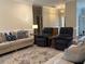 Inviting living room featuring a cozy sofa, recliner chairs, and a patterned area rug at 4001 Newby Rd, Rocky Mount, NC 27804