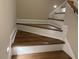 Elegant staircase with wood treads, white risers, and subtle step lighting at 4001 Newby Rd, Rocky Mount, NC 27804