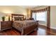 Cozy bedroom with a bed, two nightstands, hardwood floors and lots of natural light at 4038 Carpenter Pond Rd, Durham, NC 27703