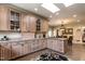 Bright kitchen with wood cabinets, granite countertops, stainless steel appliances, and view to dining area at 4038 Carpenter Pond Rd, Durham, NC 27703