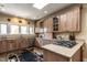 Bright kitchen with wood cabinets, granite countertops, stainless steel appliances, and a floral rug at 4038 Carpenter Pond Rd, Durham, NC 27703