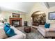 Cozy living room with fireplace, comfortable seating, and a view into the adjacent dining room at 4038 Carpenter Pond Rd, Durham, NC 27703