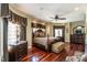 Luxurious main bedroom with hardwood floors, custom window coverings, and a ceiling fan at 4038 Carpenter Pond Rd, Durham, NC 27703