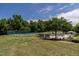 Resort-style pool and tennis court surrounded by lush greenery; perfect for outdoor leisure and recreation at 4038 Carpenter Pond Rd, Durham, NC 27703