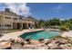 Backyard pool and patio area with landscaped rocks and outdoor seating at 4038 Carpenter Pond Rd, Durham, NC 27703