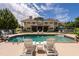 Backyard pool featuring lounge chairs, manicured landscaping and luxurious mansion at 4038 Carpenter Pond Rd, Durham, NC 27703