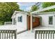 The home features a large, all-white, rear deck with a painted wood surface and traditional railing design at 407 W Sixth St, Siler City, NC 27344