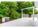 The home features a large, all-white, rear deck with a painted wood surface and traditional railing design at 407 W Sixth St, Siler City, NC 27344