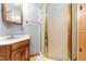 Cozy bathroom featuring an enclosed shower with gold trim and wood vanity at 407 W Sixth St, Siler City, NC 27344