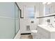 Clean bathroom featuring a shower with glass doors, an updated sink, and modern tile work at 407 W Sixth St, Siler City, NC 27344