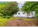 Quaint home with a well-maintained yard, showcasing a covered front porch and a back deck at 407 W Sixth St, Siler City, NC 27344