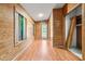 Bright hallway with wood paneling, natural light, and outdoor views through the large window at 407 W Sixth St, Siler City, NC 27344