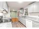 Well lit kitchen featuring stainless steel appliances, gray cabinets and an eat-in dining space at 407 W Sixth St, Siler City, NC 27344