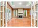 Bright living room featuring wood paneled walls, a brick fireplace, and multiple skylights for natural lighting at 407 W Sixth St, Siler City, NC 27344